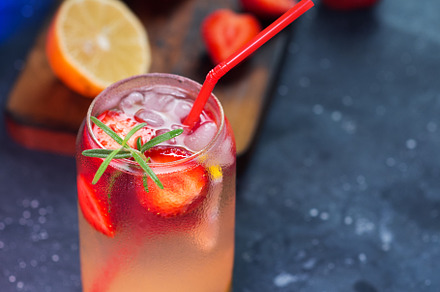 Refreshing summer strawberry mojito close-up on a black table with strawberry a, a Food & Drink Photo by PavelKant