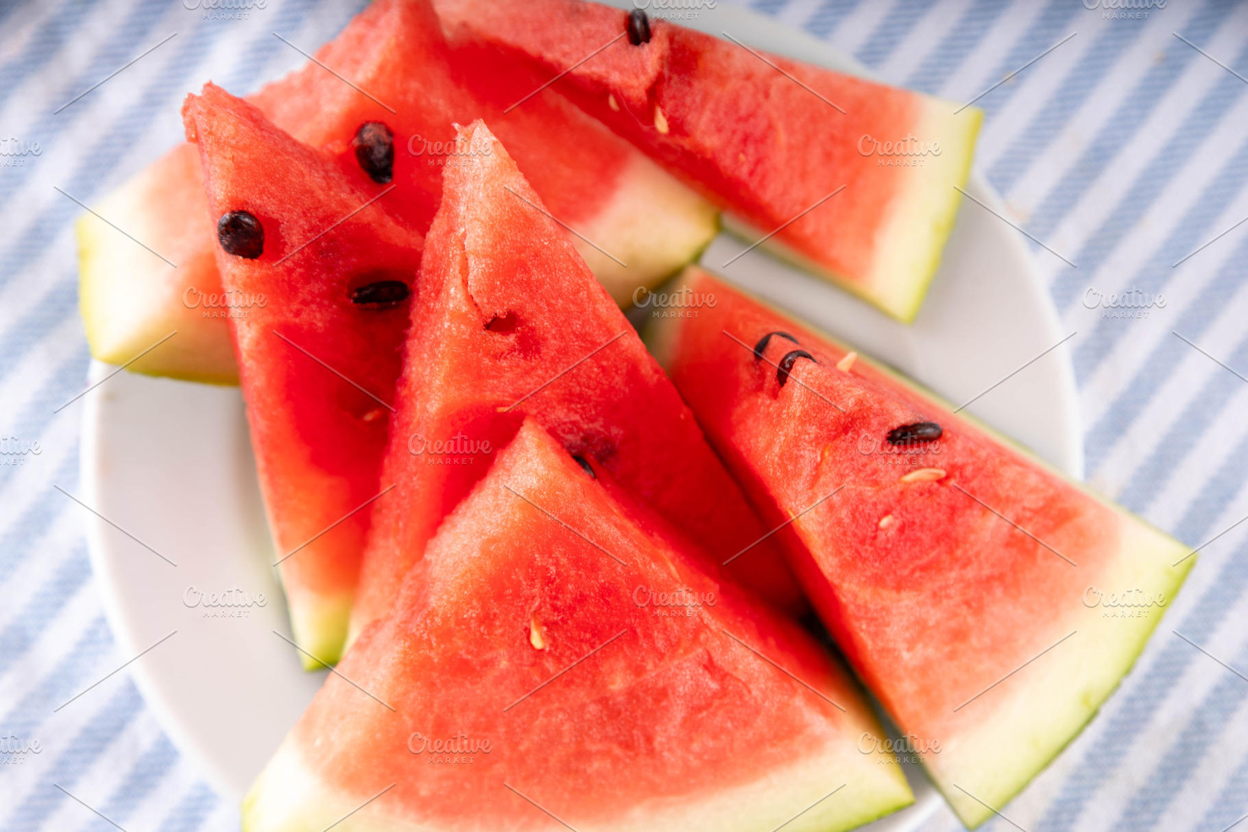 Raw ripe organic watermelon slices on kitchen table, a Food & Drink Photo by Rimma