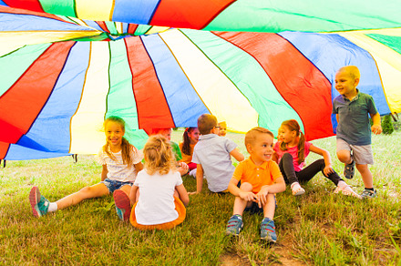 Laughing kids hide in multicolor, a School & Education Photo by oksix