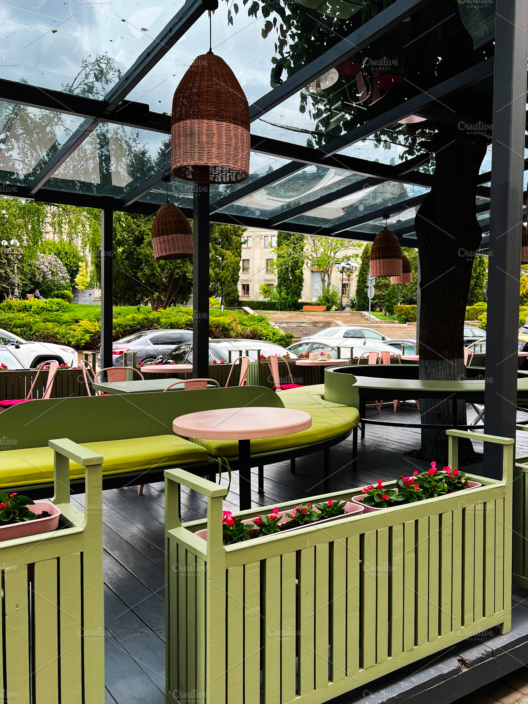 Outdoor seating area with cozy design under a transparent roof in urban setting, a Photo by AS photostudio