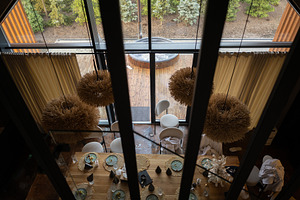 Modern dining area with natural light and outdoor wooden hot tub view, a Photo by AS photostudio