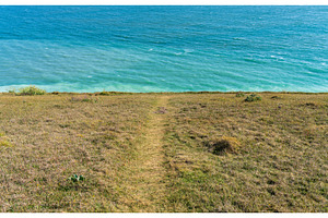 Eroding cliffs into the ocean in, a Nature Photo by Backyard Stock