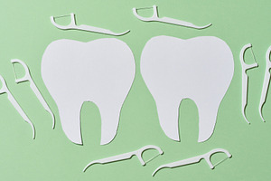 Two white paper cutouts of teeth are surrounded by multiple whit, a Health & Medical Photo by ndanko