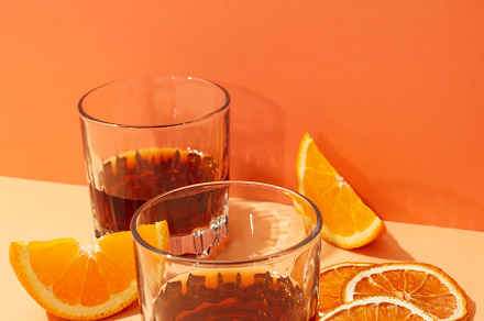 Concept of delicious alcohol drink, Whiskey with orange, a Food & Drink Photo by AtlasStudio PRO