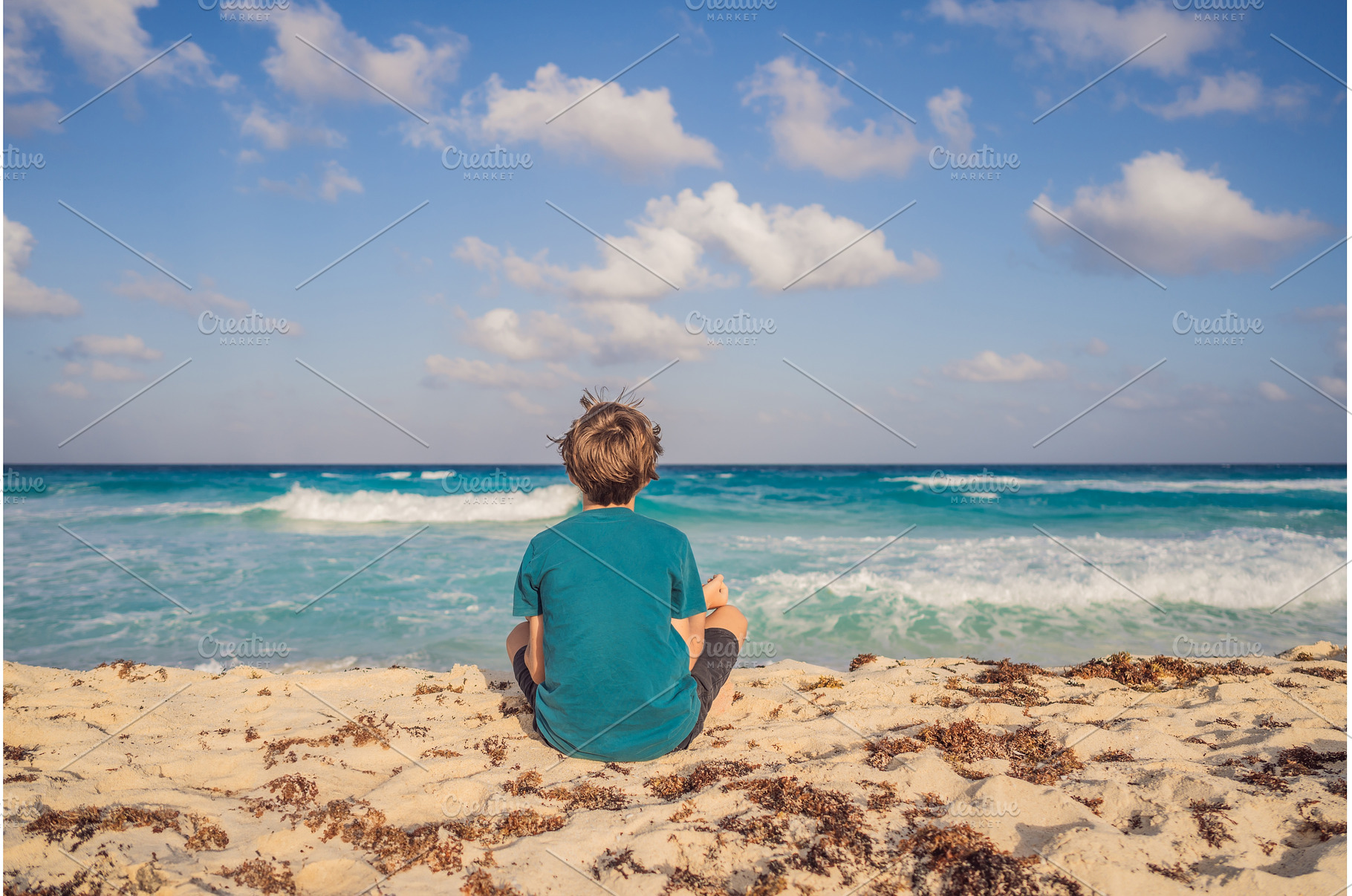 Teenage boy meditating on the sandy, a Nature Photo by Elizaveta Galitskaya