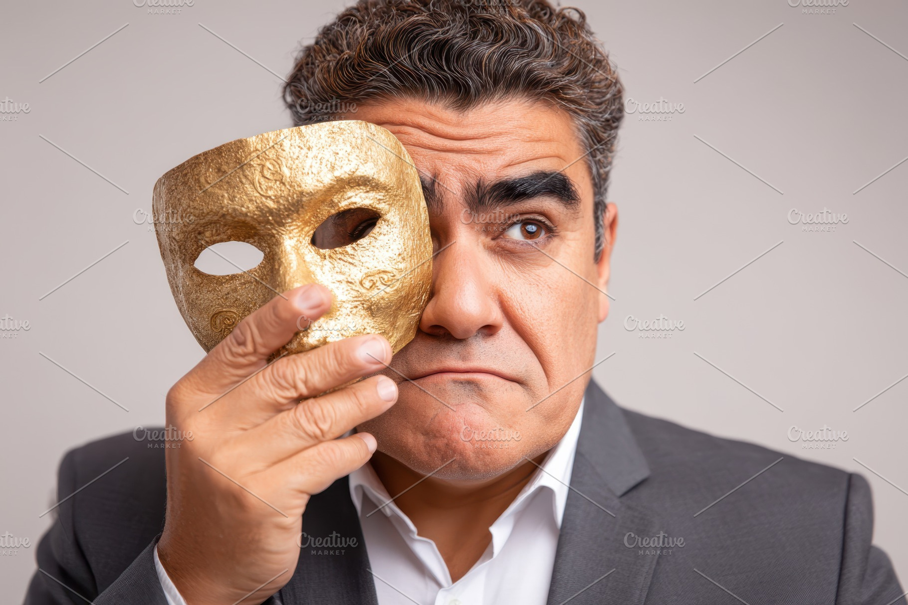 Man holding theatrical mask in contemplation, a Person Photo by AlyaAnd