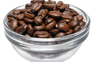 Roasted ground coffee in glass transparent bowl on isolated back, a Food & Drink Photo by ndanko