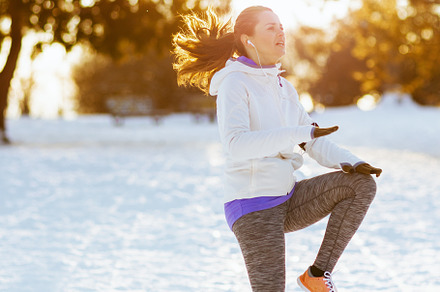 Full length portrait of young woman in white jacket workout, a Sports & Recreation Photo by Alliance Images