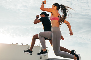 Two athletes jumping in the air, a Sports & Recreation Photo by Artem Varnitsin