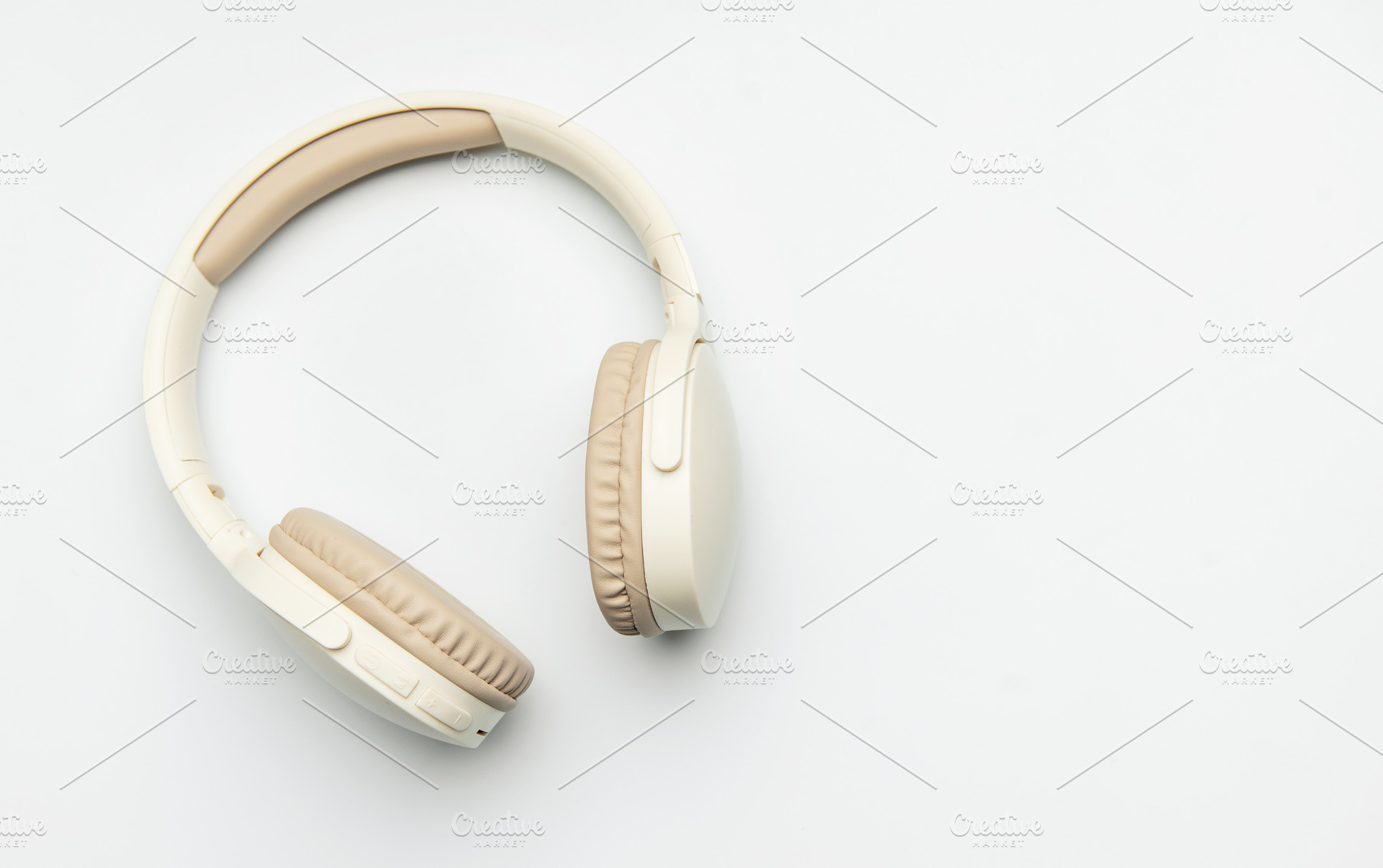 Modern wireless headphones lying on white background, a Business Photo by Olena Rudo