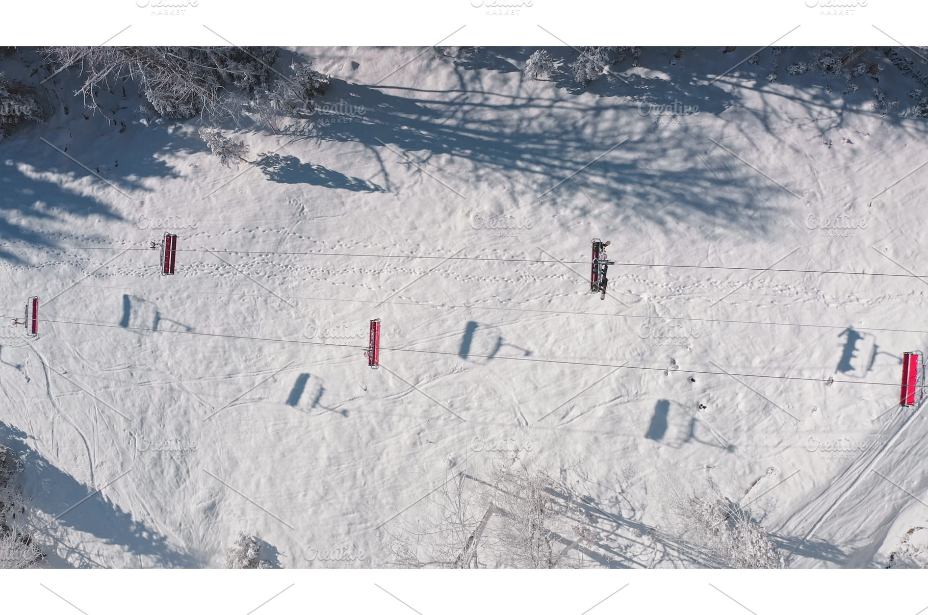 Ski lift transporting skiers up, a Nature Photo by Goinyk