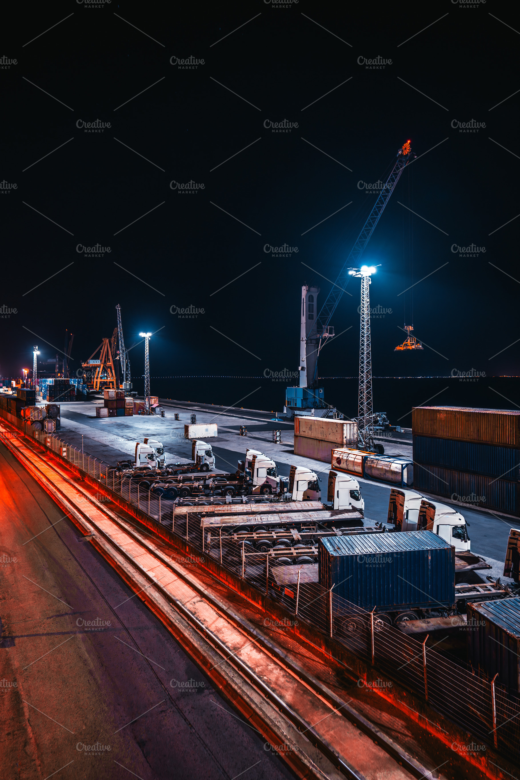 Cargo port with trucks at night, an Industrial Photo by SkyNext