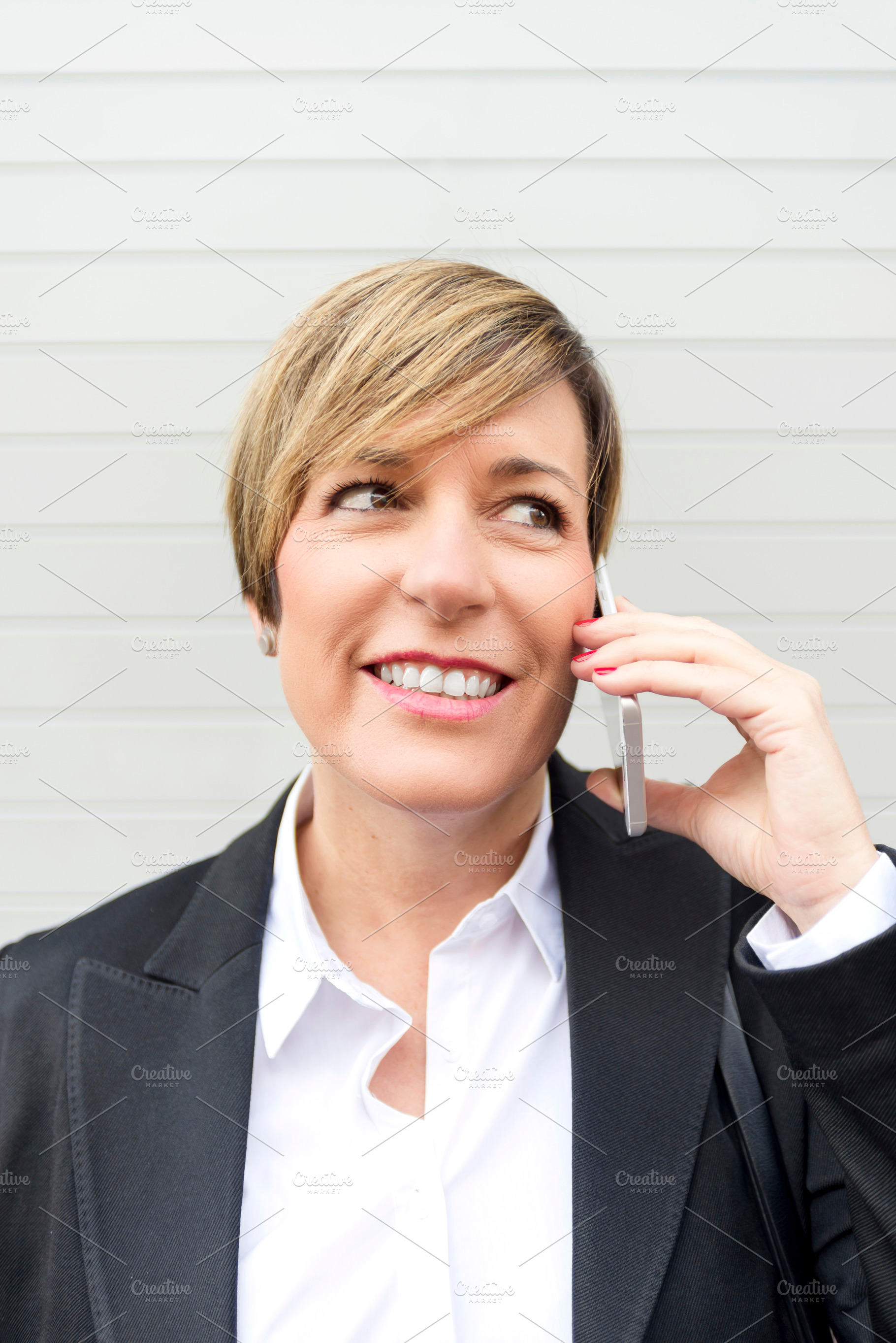 Businesswoman talking on phone close up portrait, a Photo by RF Images