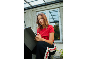 School girl uses tablet while
