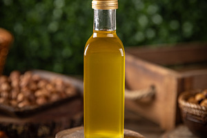 Macadamia nut oil in a glass bottle, a Photo by Grafvision photography