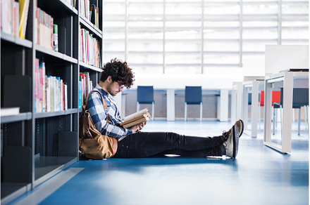 Male student in library, looking for, a School & Education Photo by HalfPoint