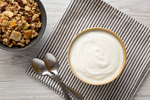 Organic Whole Fat Greek Yogurt in a Bowl, top view. Flat lay, ov, a Food & Drink Photo by LiudmylaChuhunova