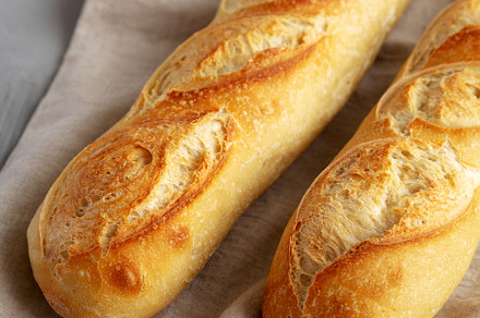 Homemade French Bread Baguette on a gray background, side view., a Food & Drink Photo by LiudmylaChuhunova