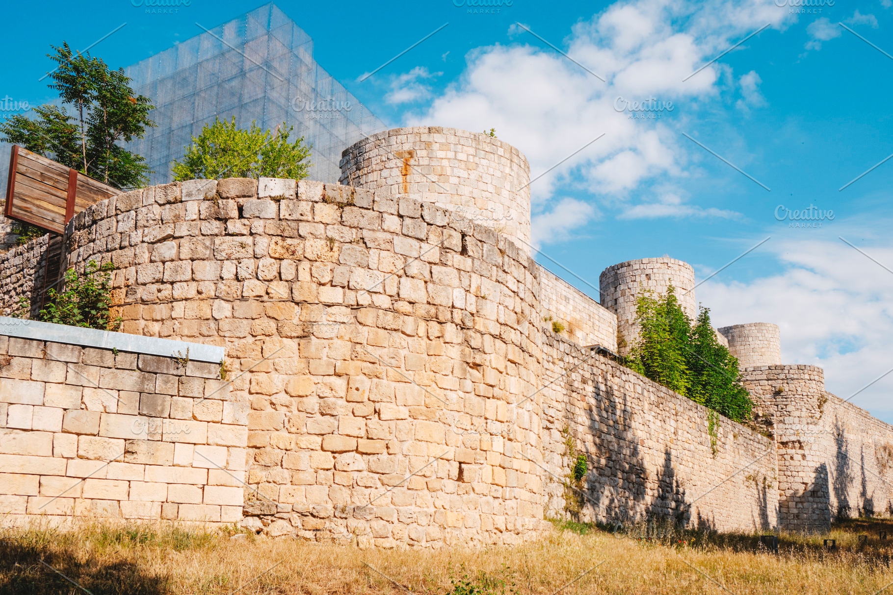 walls and towers of Burgos Castle with metal frame, a Photo by Nito