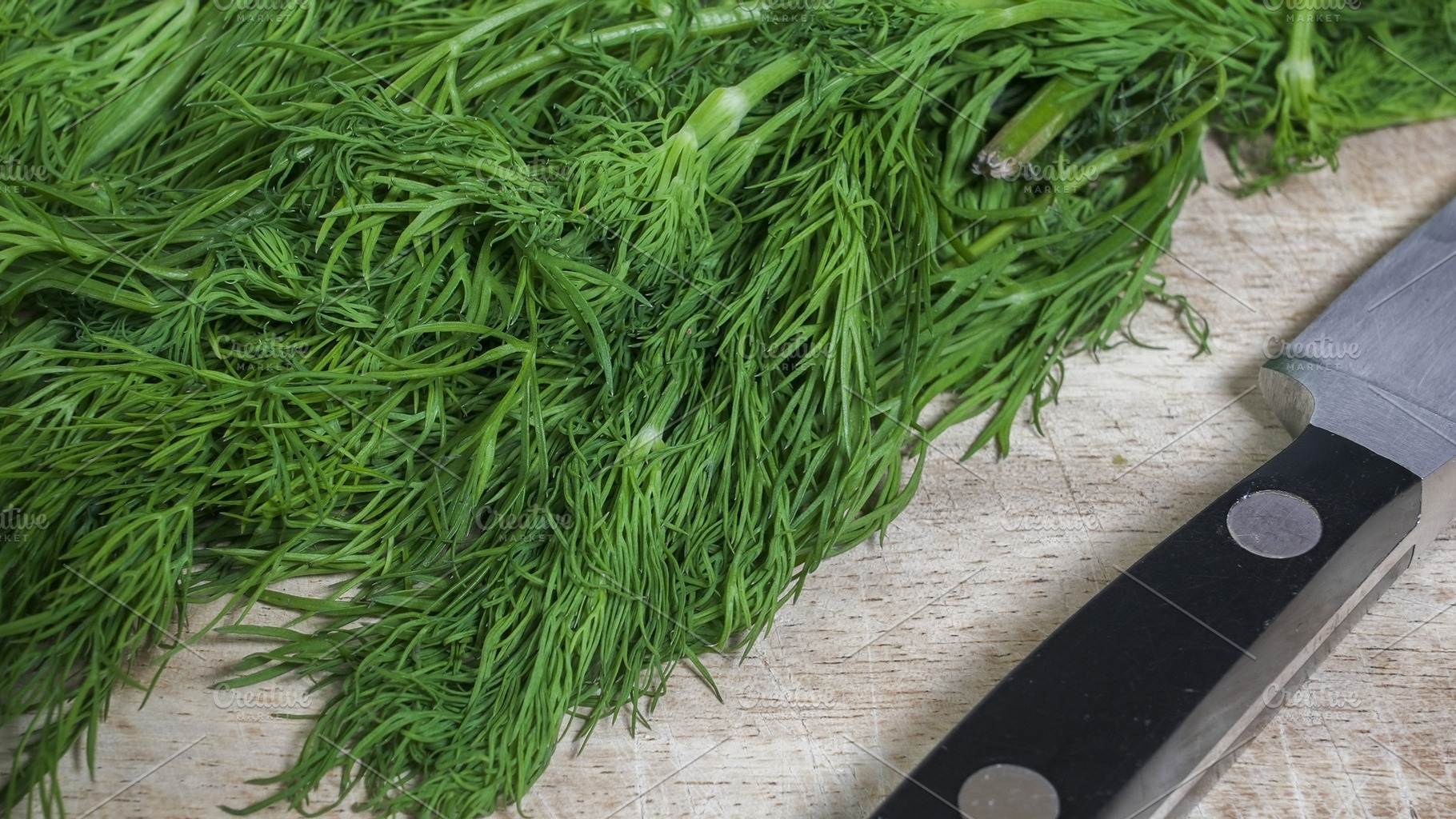 Fresh dill bunch on wooden cutting b, a Food & Drink Photo by 1miromiro