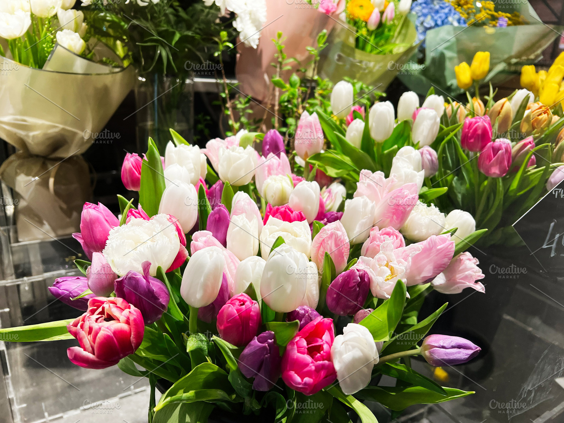Assorted tulip bouquets displayed in a vibrant and colorful floral arrangement, a Photo by AS photostudio