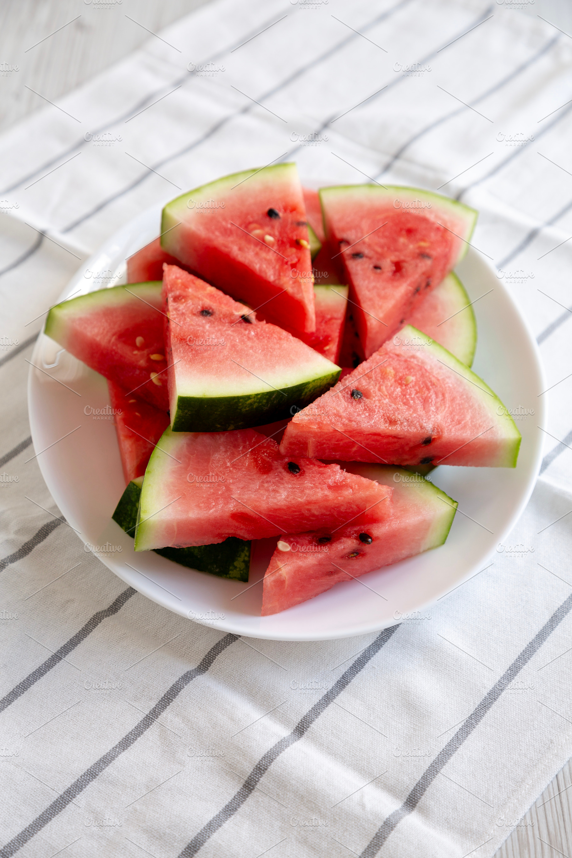 Raw Organic Watermelon Slices on a Plate, side view., a Food & Drink Photo by LiudmylaChuhunova