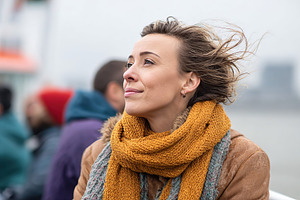 Enjoying a boat tour on a breezy day with hair blown by the wind, a Person Photo by AlyaAnd