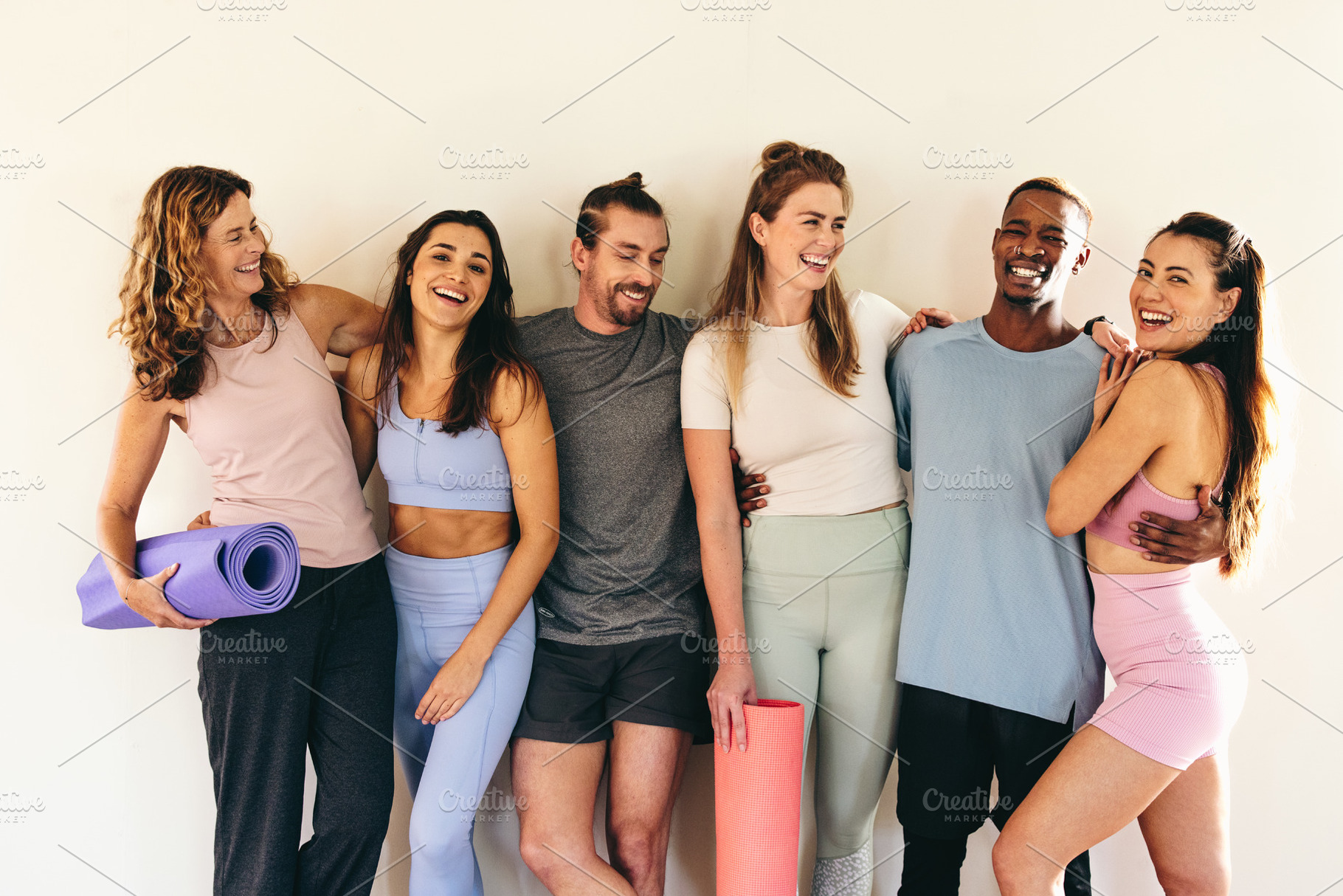 People standing as a group in a yoga studio, a Person Photo by Jacob Lund