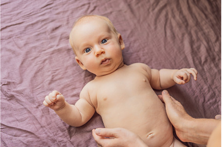 Newborn baby lying on a soft blanket