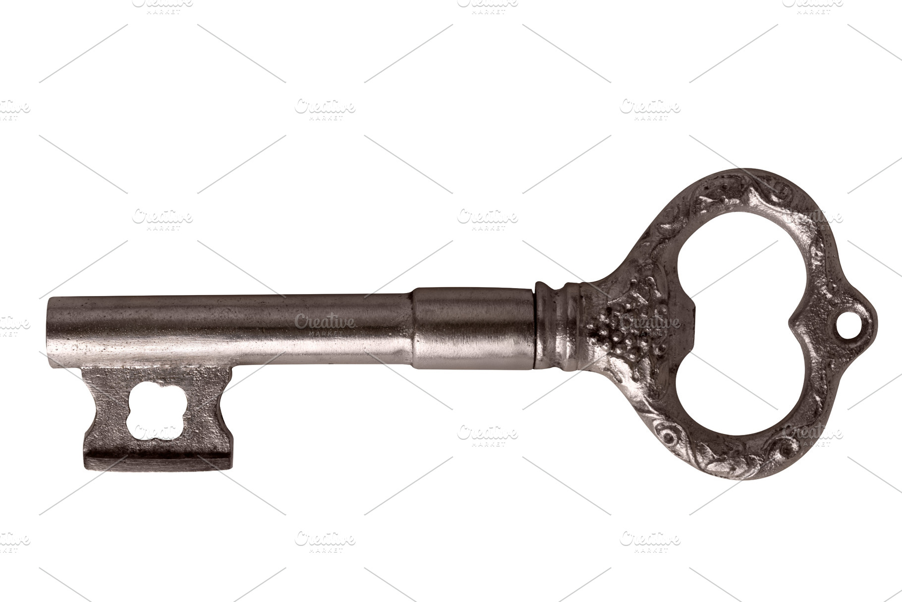 Old-fashioned silver skeleton key with ornate details, isolated, an Abstract Photo by Ales Munt