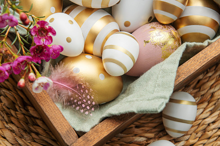 Easter decor. Colored Easter eggs in a wooden box on the table., a Holiday Photo by Olena Rudo