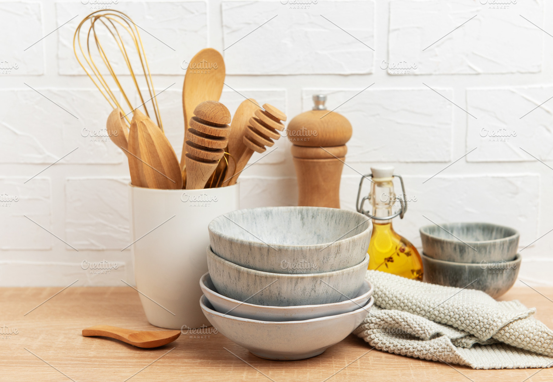 Kitchen utensils, bowls and ingredients resting on wooden counte, a Food & Drink Photo by Olena Rudo