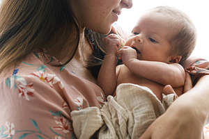 Happy Mother holding cute little baby in window light, close up., a Person Photo by Sonjachni