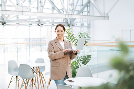Young adult woman using laptop, a Business Photo by Galina_Zhigalova
