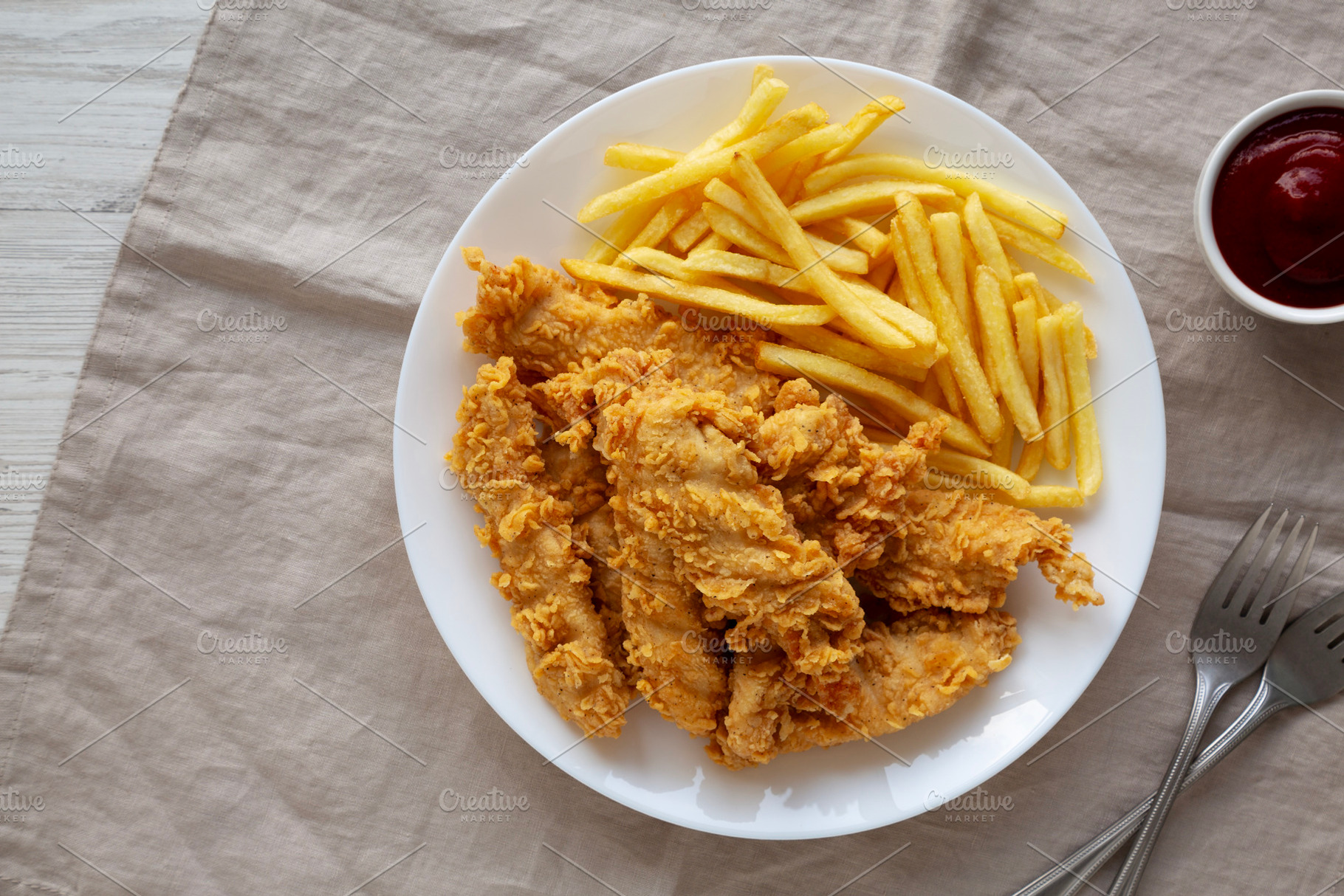 Homemade Chicken Strips with Fries on a Plate, top view., a Food & Drink Photo by LiudmylaChuhunova