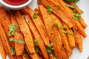 Sweet potato fries with ketchup and basil serving on plate, a Food & Drink Photo by Olena Rudo
