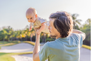 Father and newborn baby on a meadow, a Person Photo by Elizaveta Galitskaya