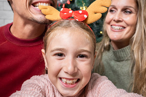 Happy family taking a Christmas selfie together at home, a Person Photo by etorres69