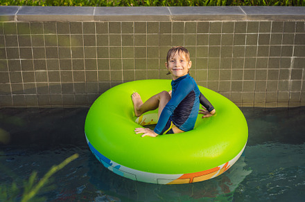 Little boy swimming with rubber ring featuring boy, leisure, and ring, a Sports & Recreation Photo by Elizaveta Galitskaya