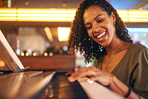 Adult pianist performing at the piano in a small bar, a Person Photo by DanFLCreativo