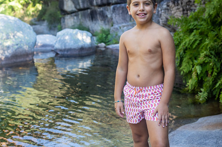 Little boy near of a river at summer