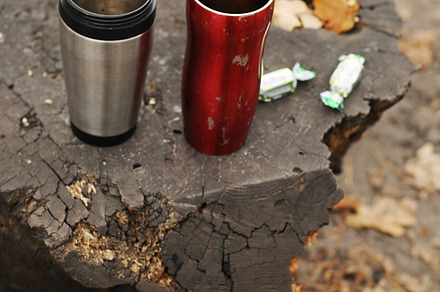 Two thermoses in woods
