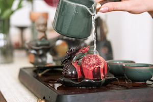 Pomegranate tea figurine chinese ceremony hand, a Person Photo by Photo Drive Studio