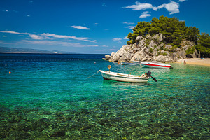 Beautiful beach and moored boats, a Nature Photo by Alpine Dreams