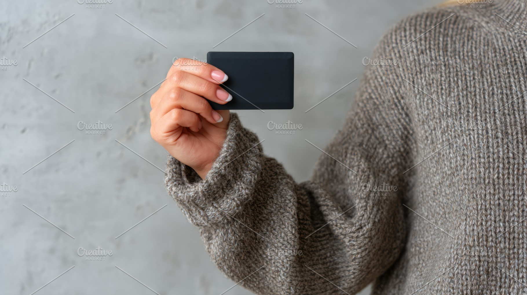 A woman with light skin holding a minimalist black card against a neutral backd, a Business Photo by ImageMir