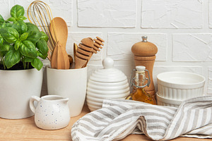 Kitchen utensils, basil plant and linen napkin creating cozy atm, a Food & Drink Photo by Olena Rudo