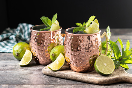 Moscow mule cocktail served with ice and lime slice on wooden ta, a Food & Drink Photo by etorres69