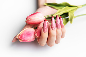 Woman's hand holding tulips with stiletto nails, a Beauty & Fashion Photo by Olena Rudo