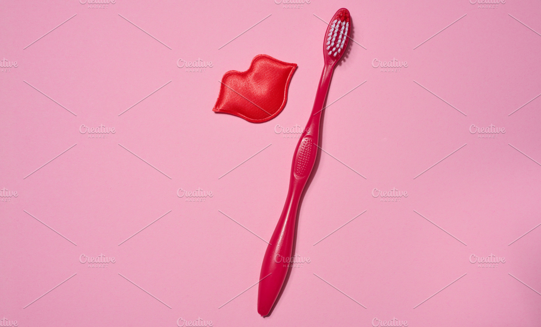 Red toothbrush and red decorative lips placed on a pink backgrou, a Health & Medical Photo by ndanko