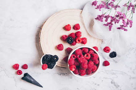 Blackberries, raspberries on marble, a Food & Drink Photo by Zama Studio